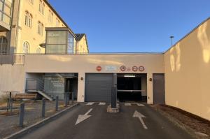Entrée du parking couvert Centre Colbert avec signalisation de hauteur, barrière d'accès et ascenseur.