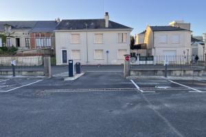 Voie de sortie sécurisée avec barrière automatique, borne de validation et panneau stop.