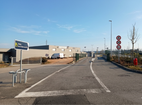 Zoom sur la voie de sortie du parking P2 Mâcon-Loché : l'infrastructure comprend des barrières automatiques, des bornes de paiement par carte et une signalétique tarifaire complète pour faciliter le départ des usagers.