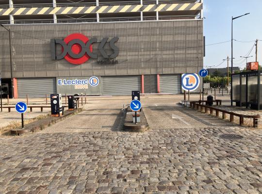 Emplacements réservés à la recharge des véhicules électriques aménagés sur sol pavé face au bâtiment des Docks Vauban.