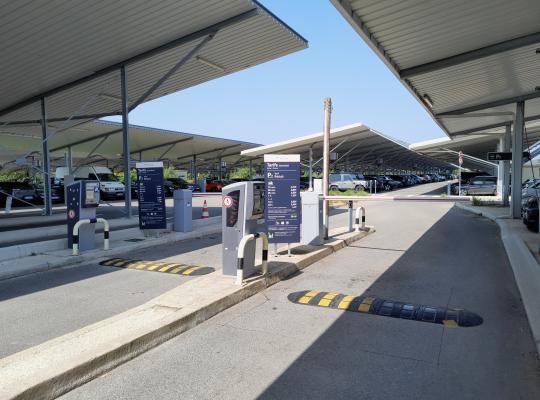 Voies d'accès couvertes avec bornes de contrôle et panneaux tarifaires au parking EFFIA P7.
