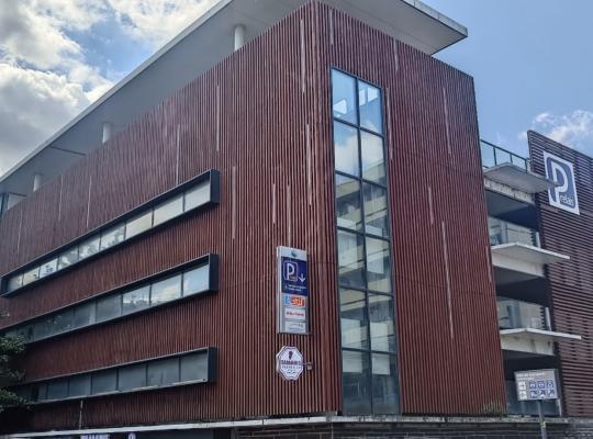 Façade extérieure moderne du bâtiment du parc relais avec bardage en bois.