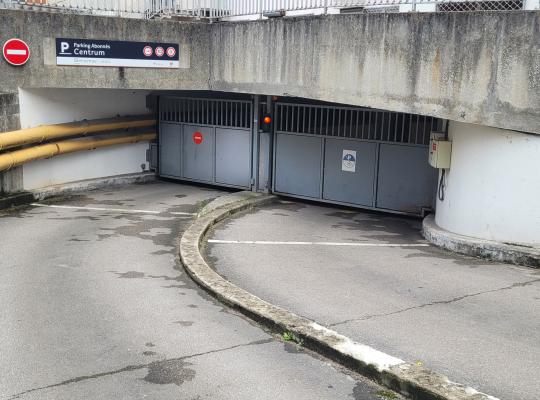 Rampe d'accès descendant vers la porte automatique du parking réservé aux abonnés Centrum.